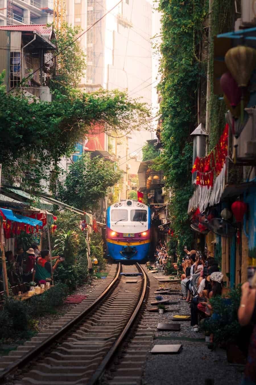 Local train passing through the residential corridor of Hanoi Train Street. 